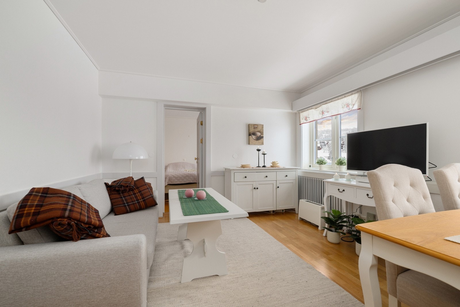 Stuen har parkett på gulvet og plass til både sofagruppe og spisebord. Galleribilde