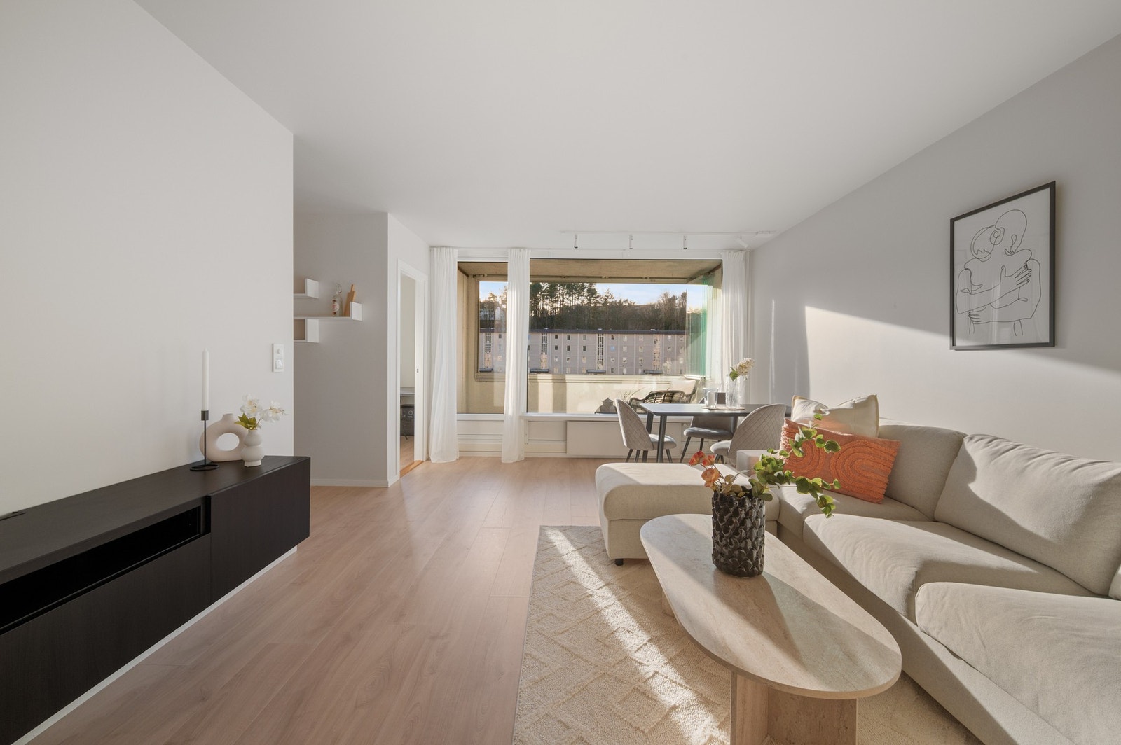 Videre inn i leiligheten møter du boligens hjerterom - stuen. Galleribilde