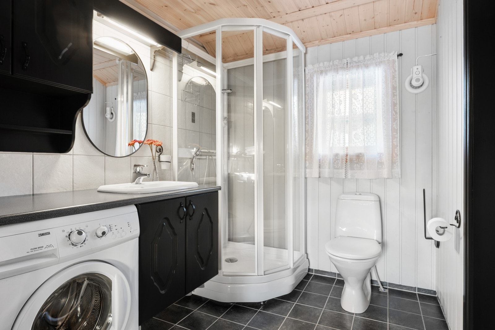 Badet utgjør 4,5m² og er utstyrt med dusjkabinett, servant i innredning, wc, opplegg for vaskemaskin og mekanisk avtrekk. Galleribilde