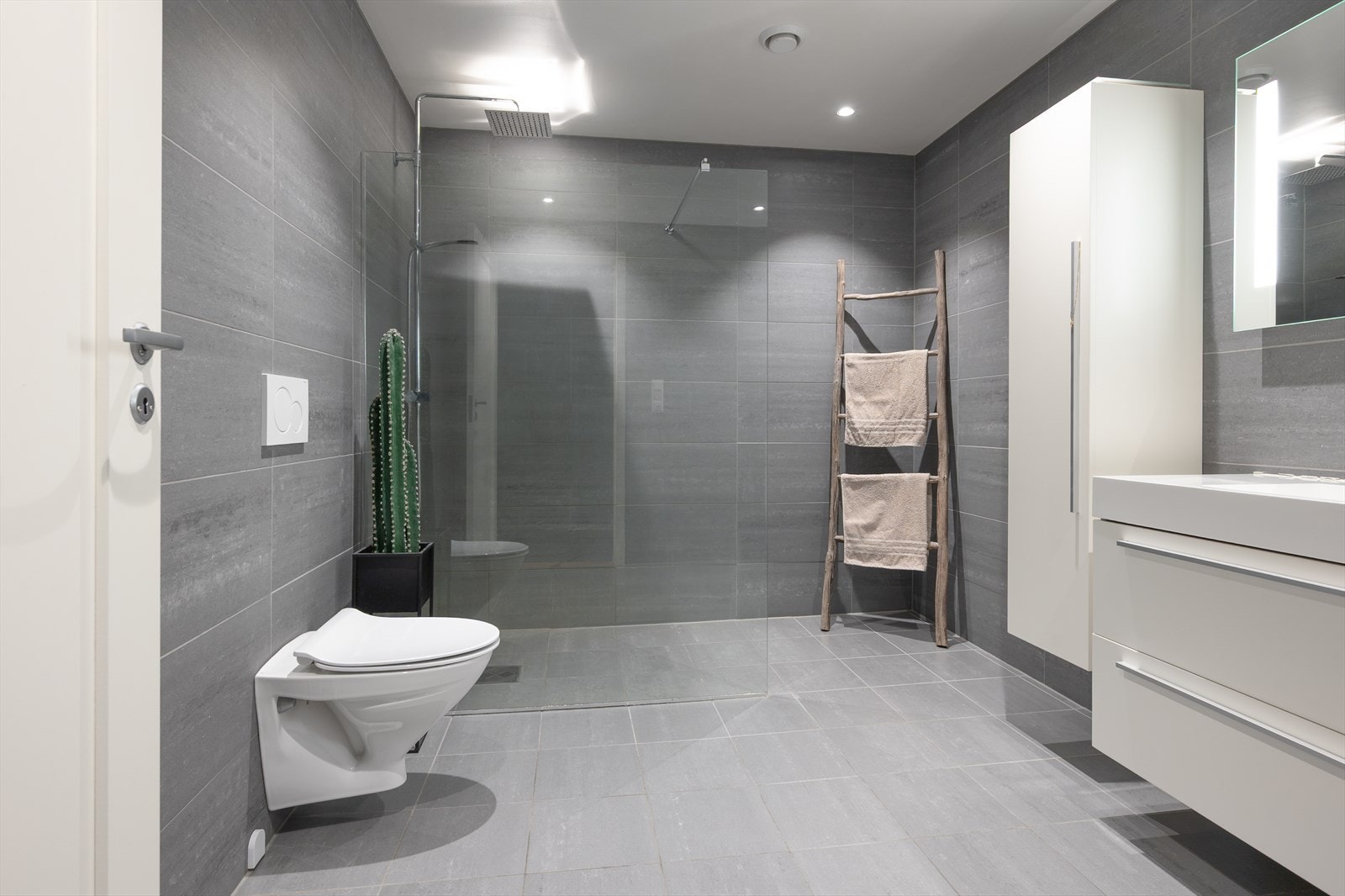 Helfliset bad med varmekabler, vegghengt wc og regndusj Galleribilde