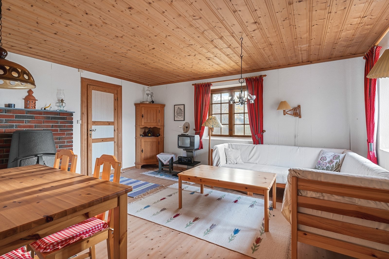 Stuen i underetasjen har behandlet furugulv og en vedovn for ekstra varme. Galleribilde