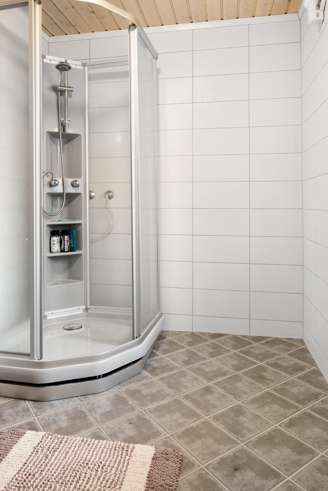 Baderommet har fliser på gulv og vegger Galleribilde