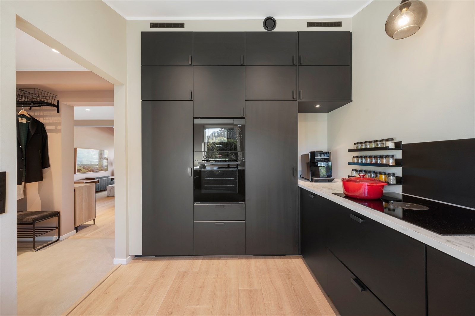 Kjøkkeninnredningen har slette, sorte fronter og laminert benkeplate som gir et moderne og stilrent uttrykk. Galleribilde