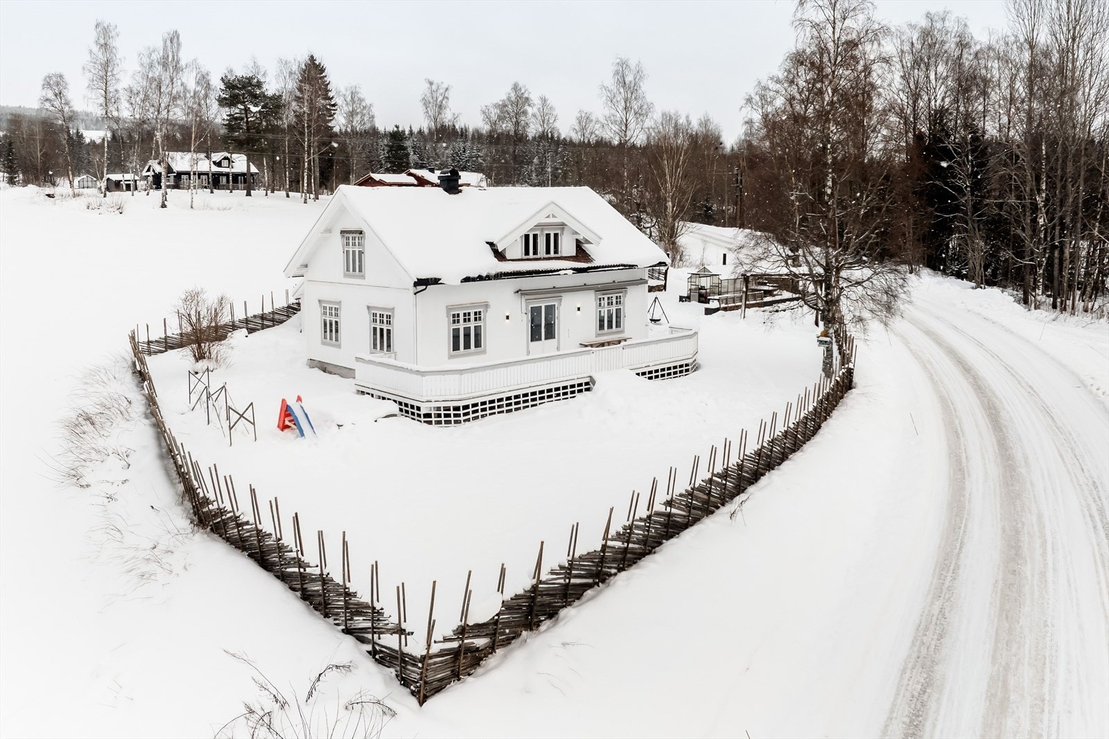 En solrik og flott eiendom som er innhegnet med skigard og pent opparbeidet med plen, beplantning og drivhus. Galleribilde