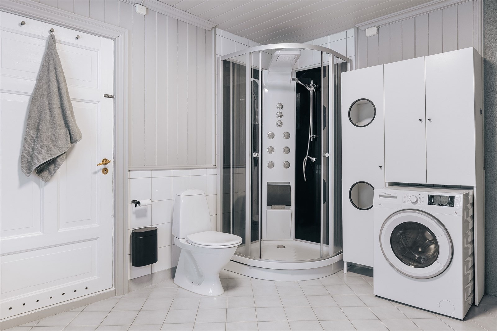 Baderommet er også utstyrt med dusjkabinett, gulvstående toalett og opplegg for vaskemaskin. Galleribilde