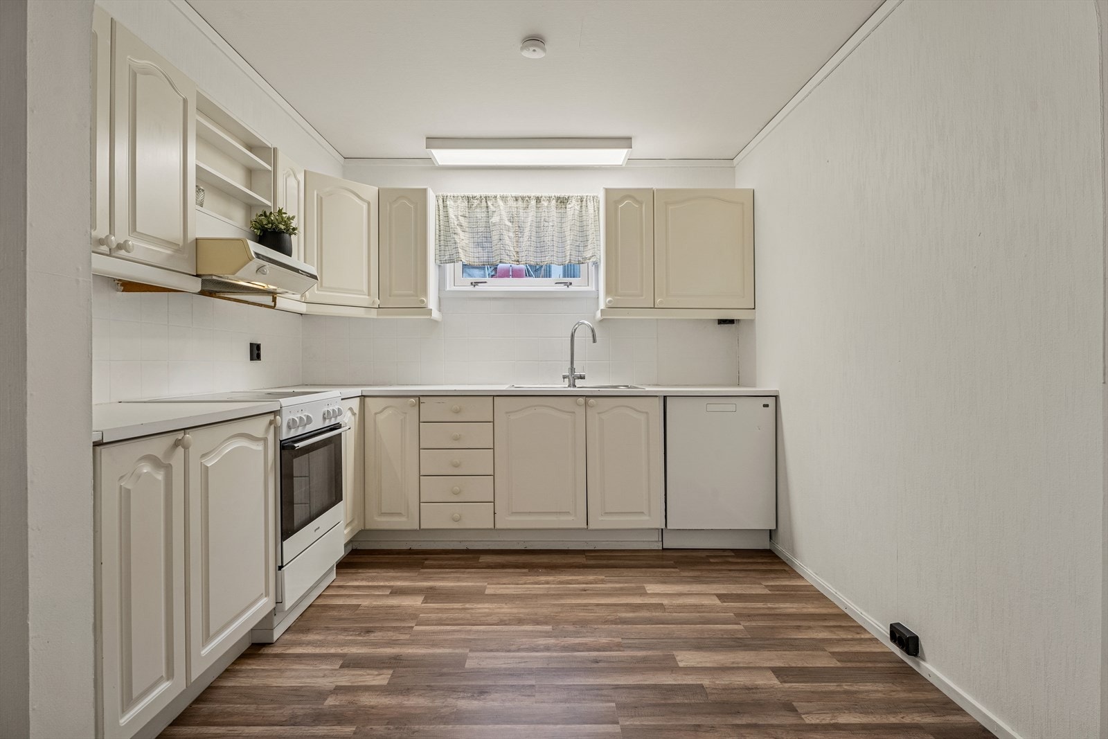 Kjøkkenet som er fra byggeåret ligger fint tilbaketrukket fra selve stuen. Galleribilde