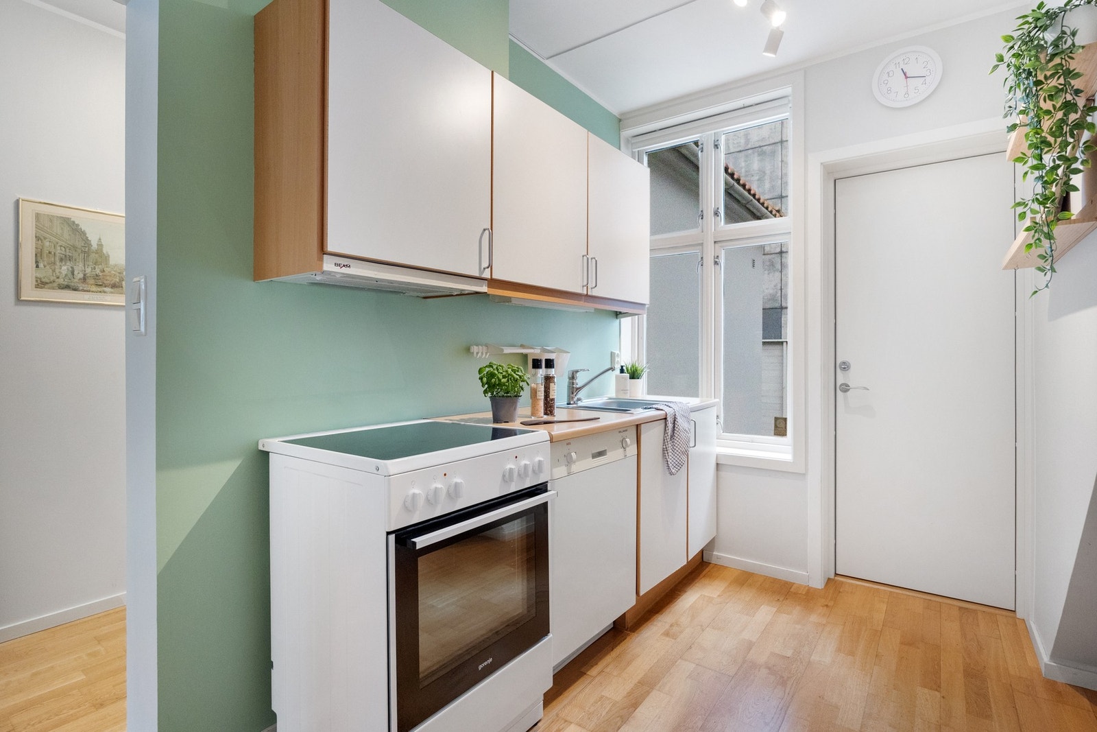 Kjøkkenet er innredet med slette fronter og laminert benkeplate Galleribilde