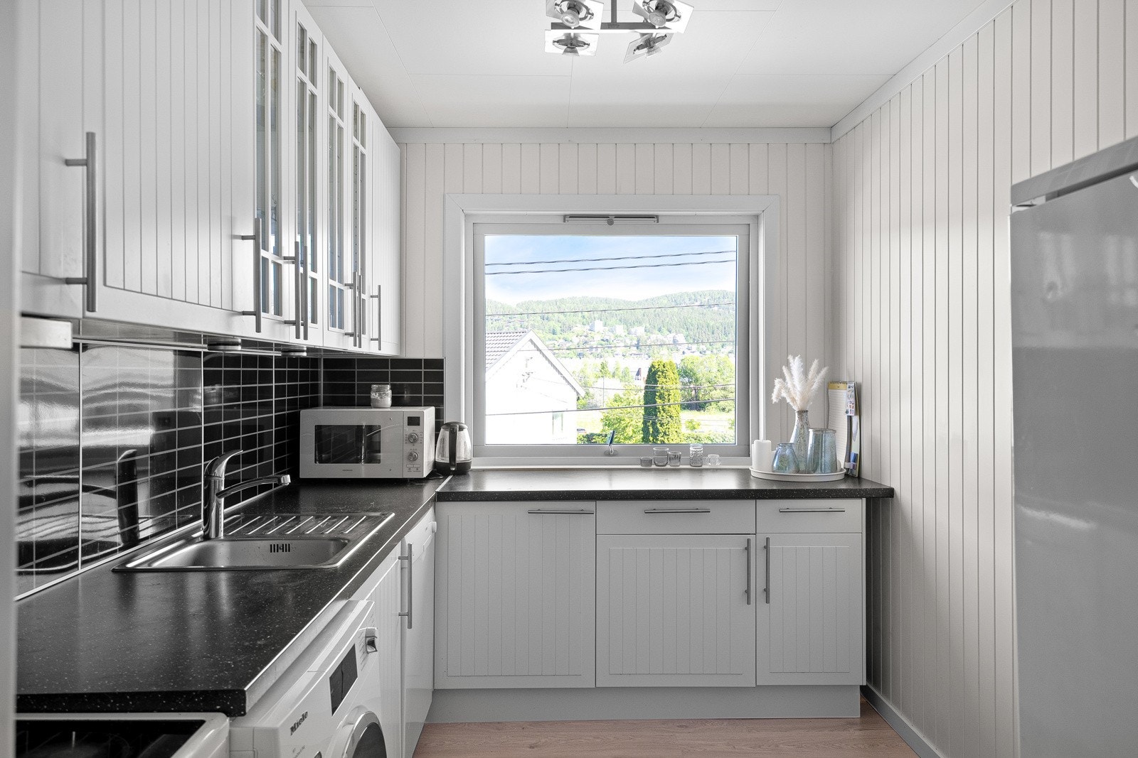 Kjøkkenet i andre etasje har også kjøkken oppgradert i 2011 fra IKEA. Innredningen har hvite, profilerte fronter og en laminert benkeplate med nedfelt utslagsvask. Galleribilde