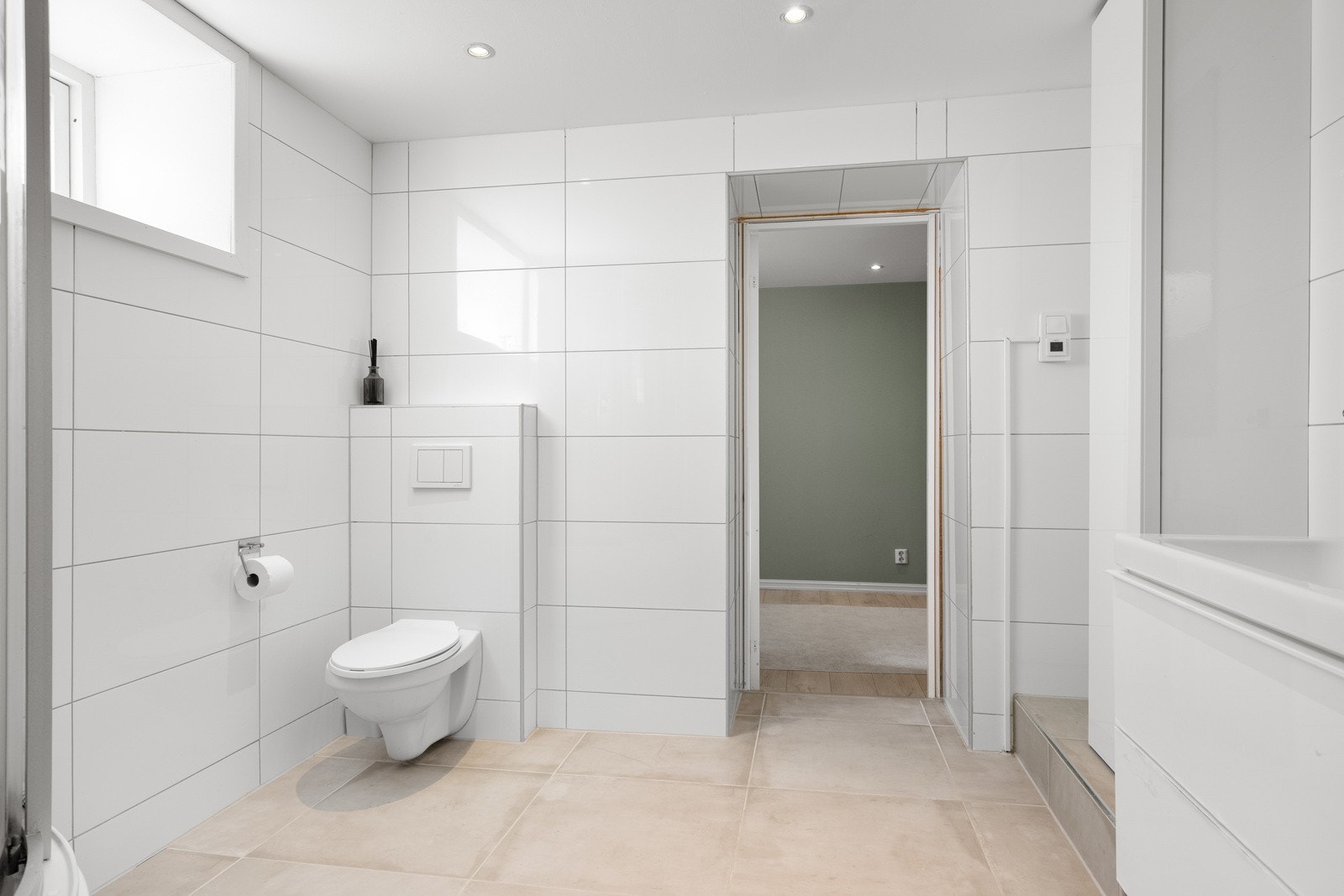 Det vegghengte toalettet bidrar til et ryddig og moderne uttrykk. Rommet er kompakt, men godt utnyttet - og det finnes muligheter for å tilpasse ytterligere oppbevaring etter behov. Galleribilde