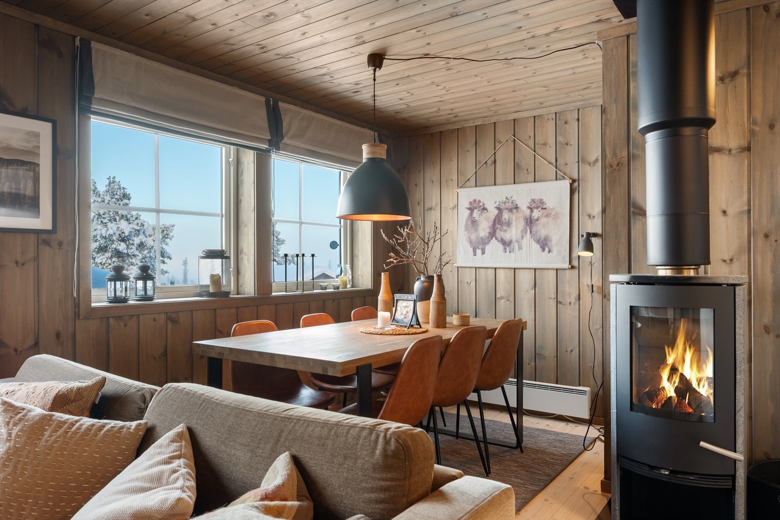 Her kan man samle flere rundt bordet og nyte varmen og hyggen fra peisovnen. Galleribilde