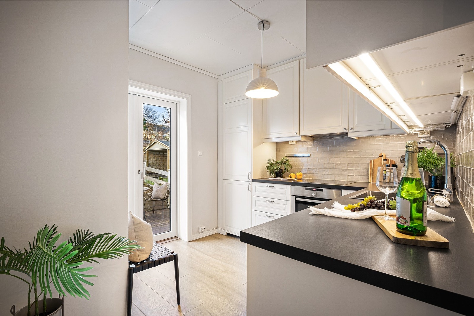 - Fra kjøkkenet er det utgang via en pen 2-fløyet balkongdør til terrassedekke og videre til den hyggelige hagen - Galleribilde