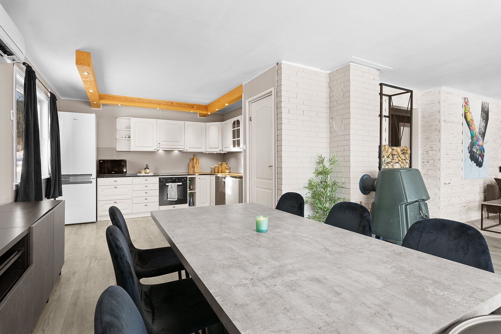 I tillegg til vannbåren varme er det vedovn og varmepumpe i stuen Galleribilde