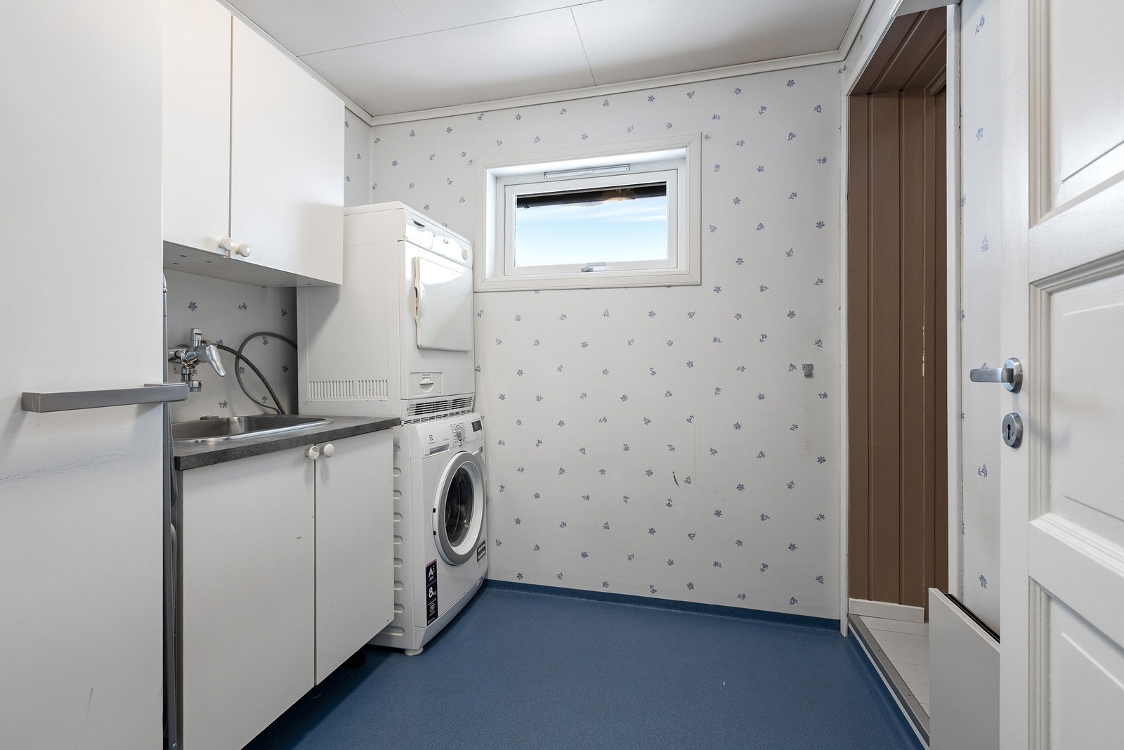 Ved siden av badet i 1. etasje ligger et praktisk vaskerom med gode løsninger for klesvask og oppbevaring. Galleribilde