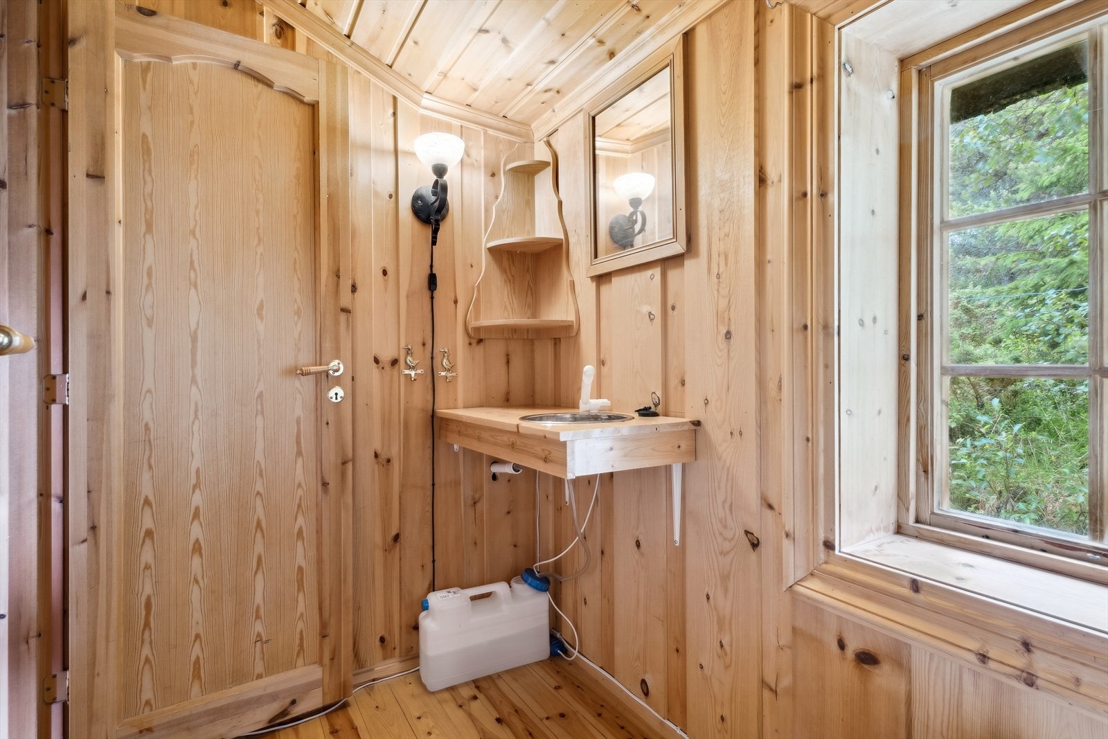 Toalettrommet er innredet med et portabelt toalett, og en servant som er tilkoblet en 12V pumpe med en egen vannbeholder. Galleribilde