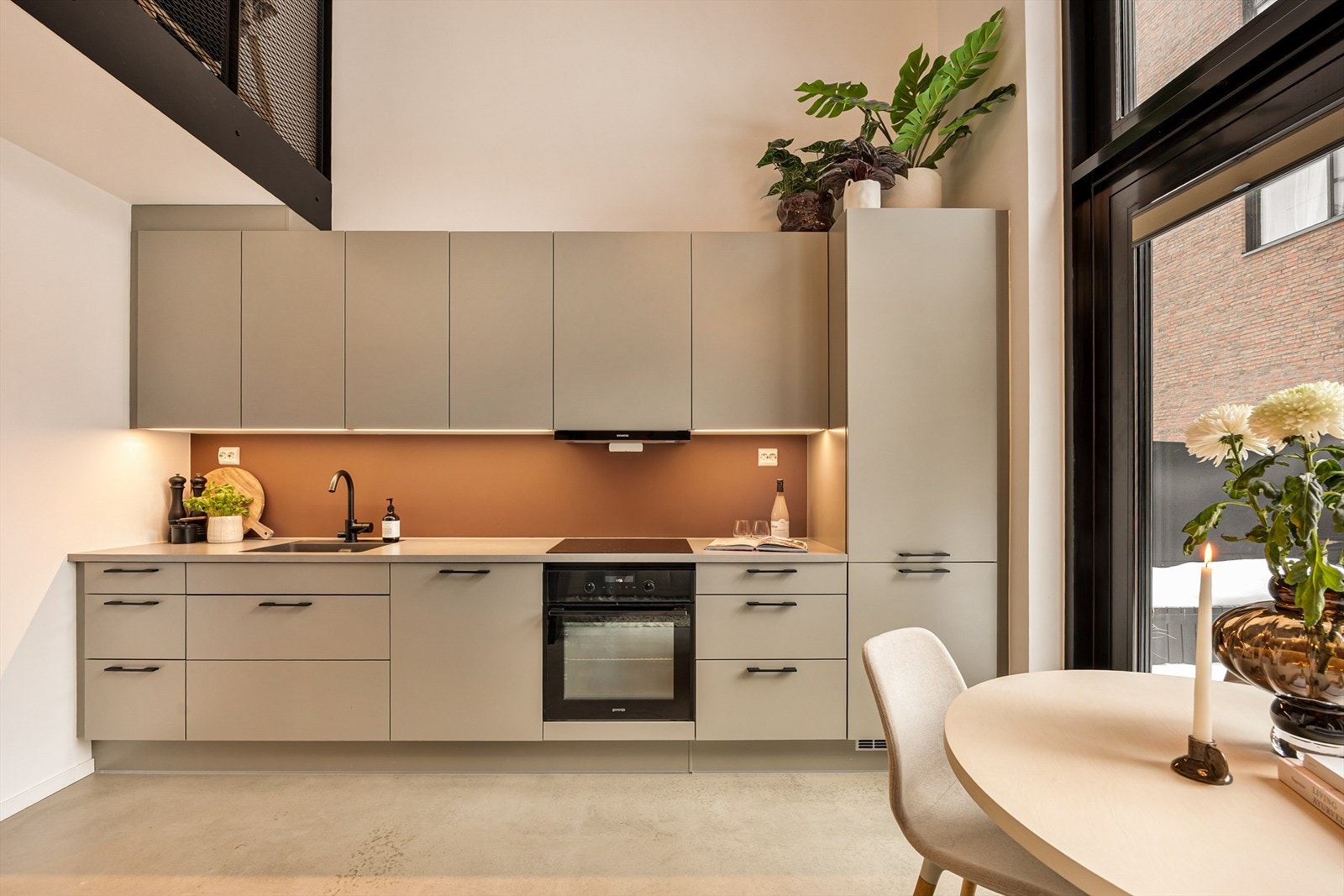 Kjøkkeninnredningen har slette fronter og laminat benkeplate med nedfelt kjøkkenkum. Galleribilde