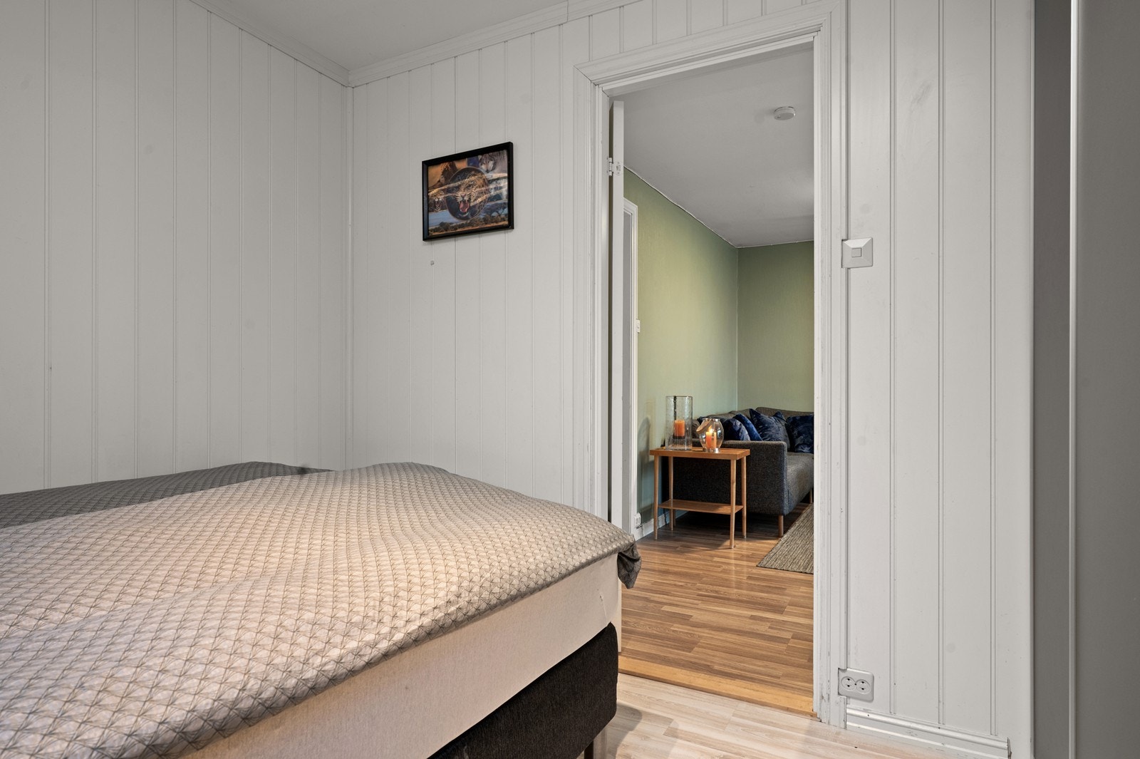 Soverommet har vegger med malte plater og laminat på gulvet. Det er atkomst til soverommet fra stuen. Galleribilde