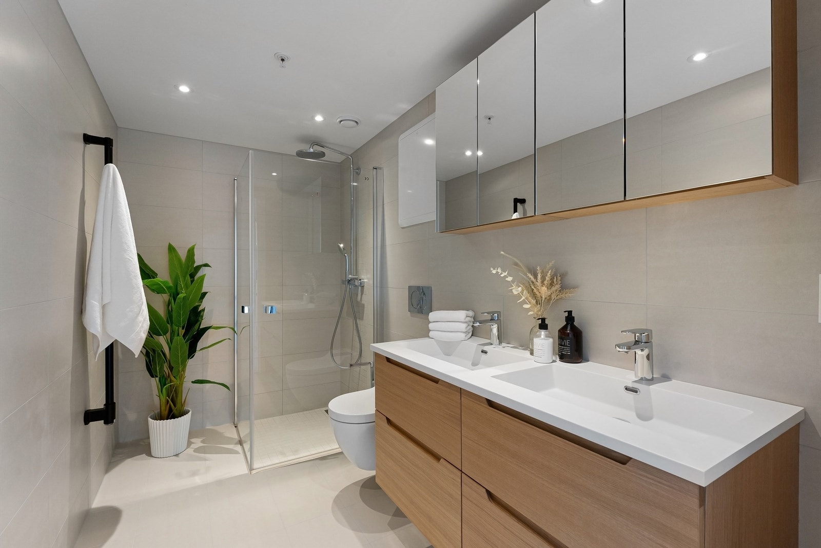 Lekkert og flislagt baderom med gulvvarme og downlights. Regnfallsdusj Galleribilde