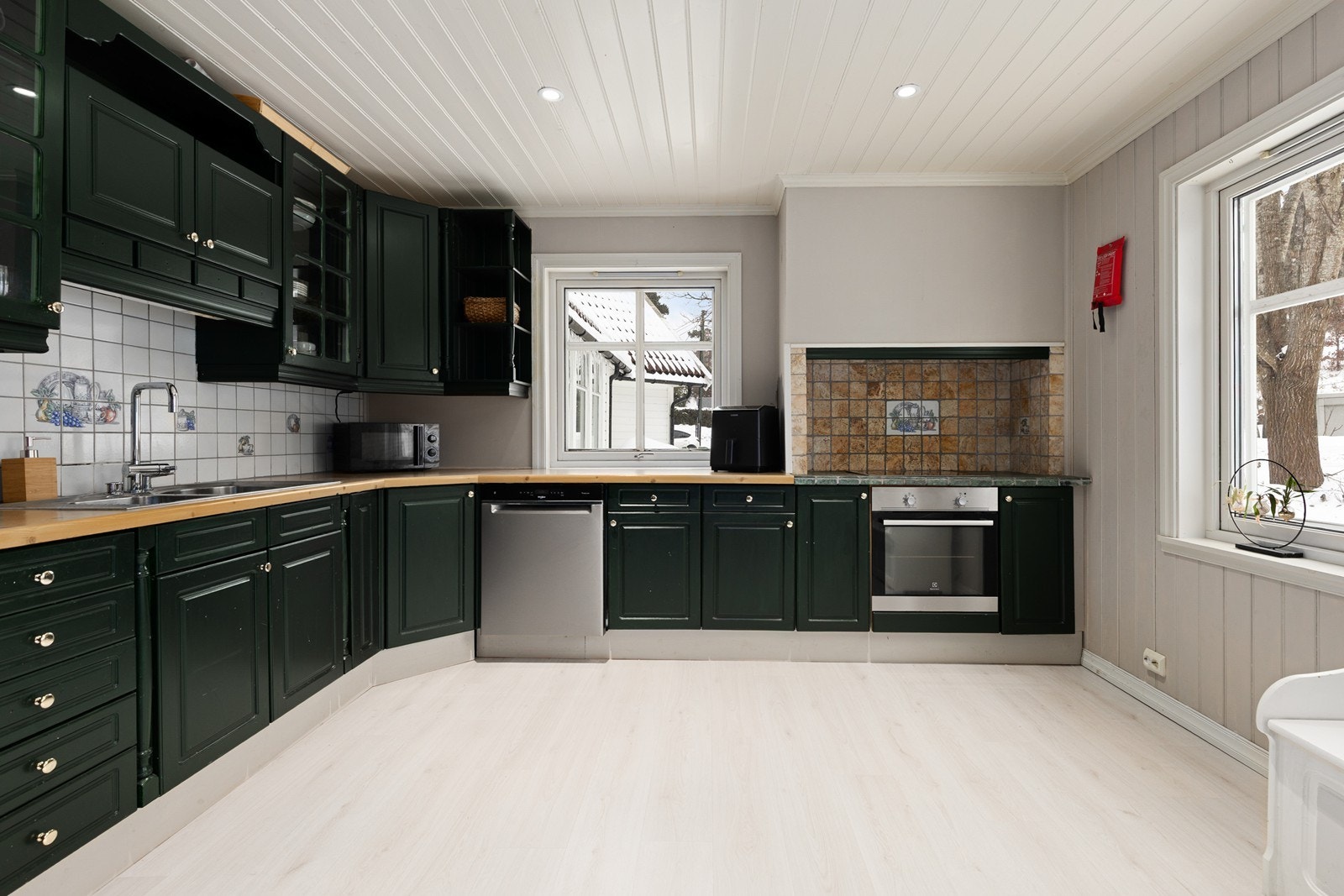 Romslig kjøkken med mye skap- og benkeplass Galleribilde