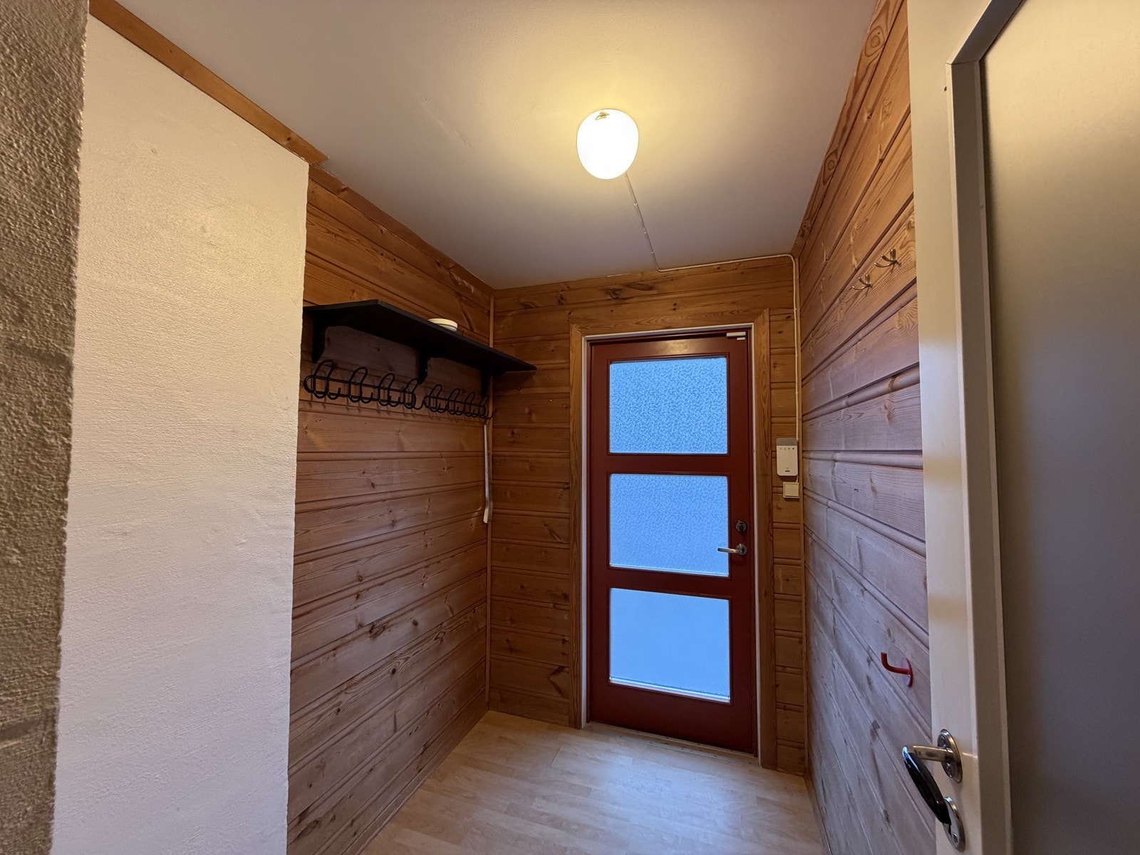 Lys entre med plass til å henge fra seg ytterklær. Galleribilde