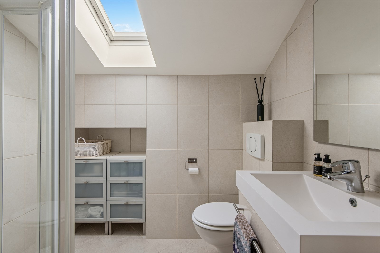 Baderommet på loftet har flislagte vegger og gulv med gulvvarme, og er utstyrt med et praktisk dusjkabinett. Galleribilde