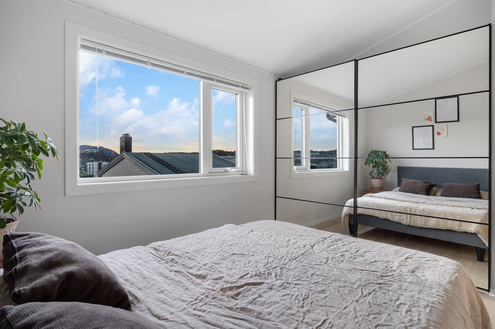 Skyvedørsgarderobe med speilfronter gir romslig oppbevaringsløsning i soverommet. Galleribilde