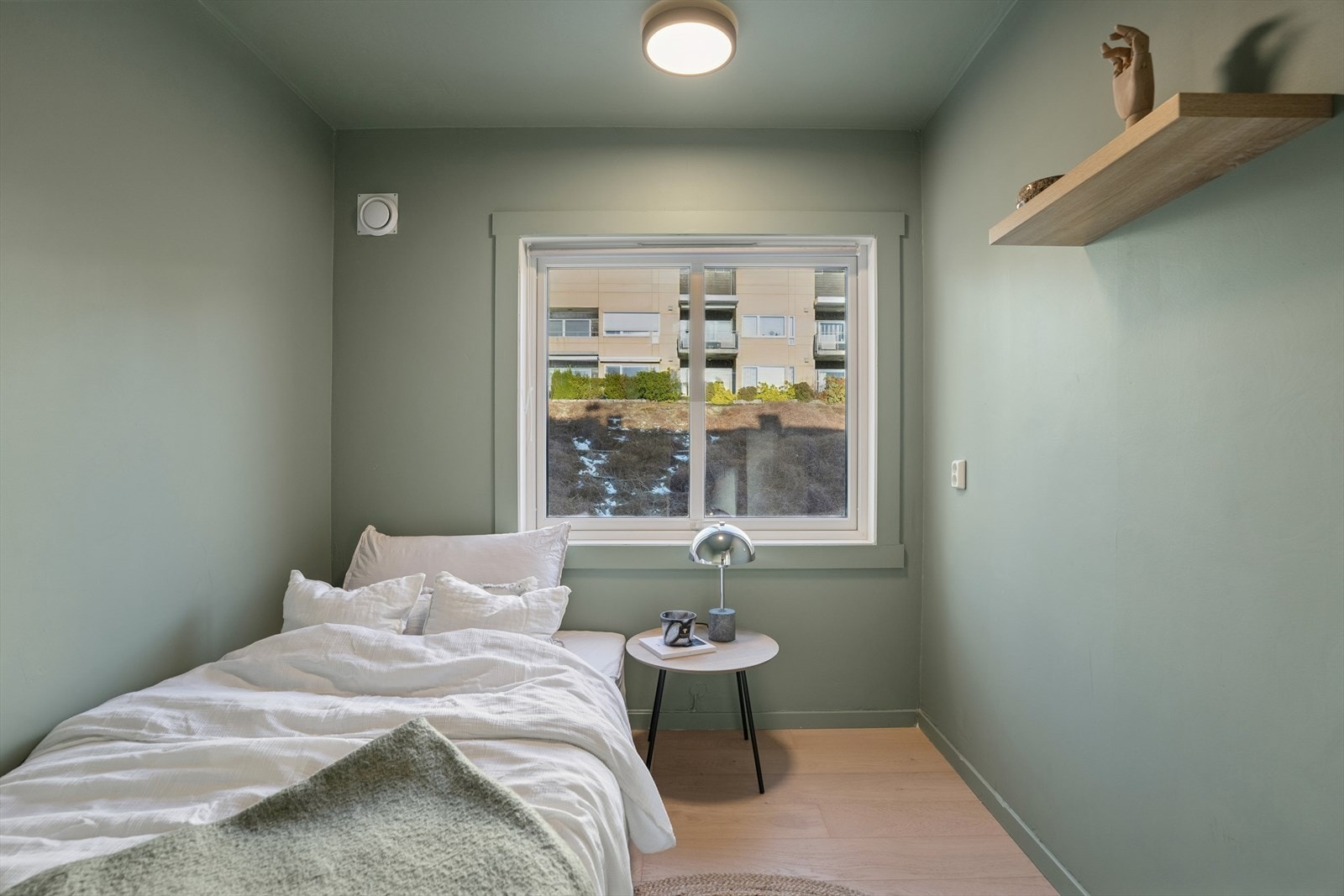 Fra vaskerommet er det videre tilgang til ett av leilighetens soverom. Soverommet har god plass til både seng og øvrig møblement. Dette er et fleksibelt rom som egner seg perfekt som gjesterom eller barnerom. Galleribilde