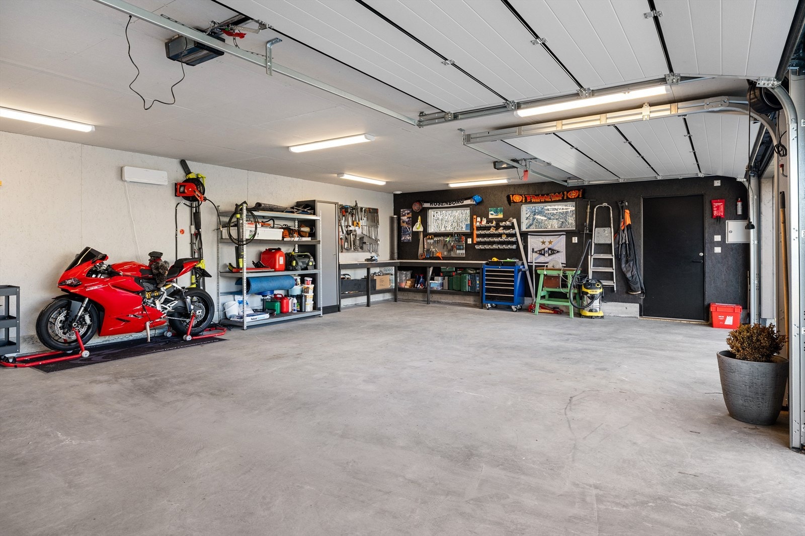 Det er lagt inn strøm og lagt til rette for elbil-lading. Automatiske porter og tilkomst via sidedør. Galleribilde