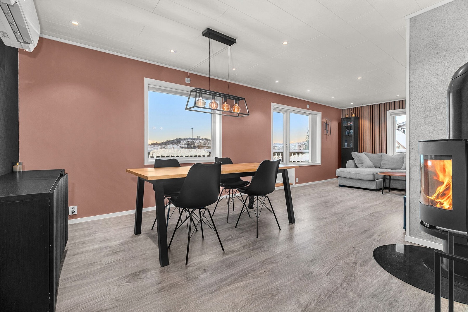 Romslig stue med moderne vedovn og varmepumpe Galleribilde