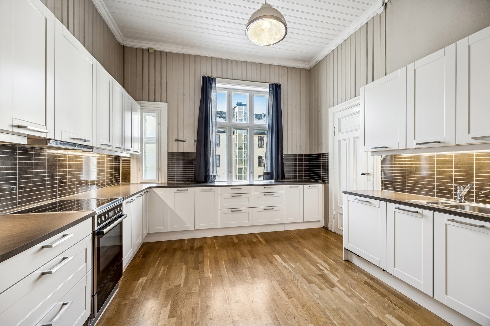 Romslig kjøkken med rikelig av oppbevaring og benkeplass. Galleribilde