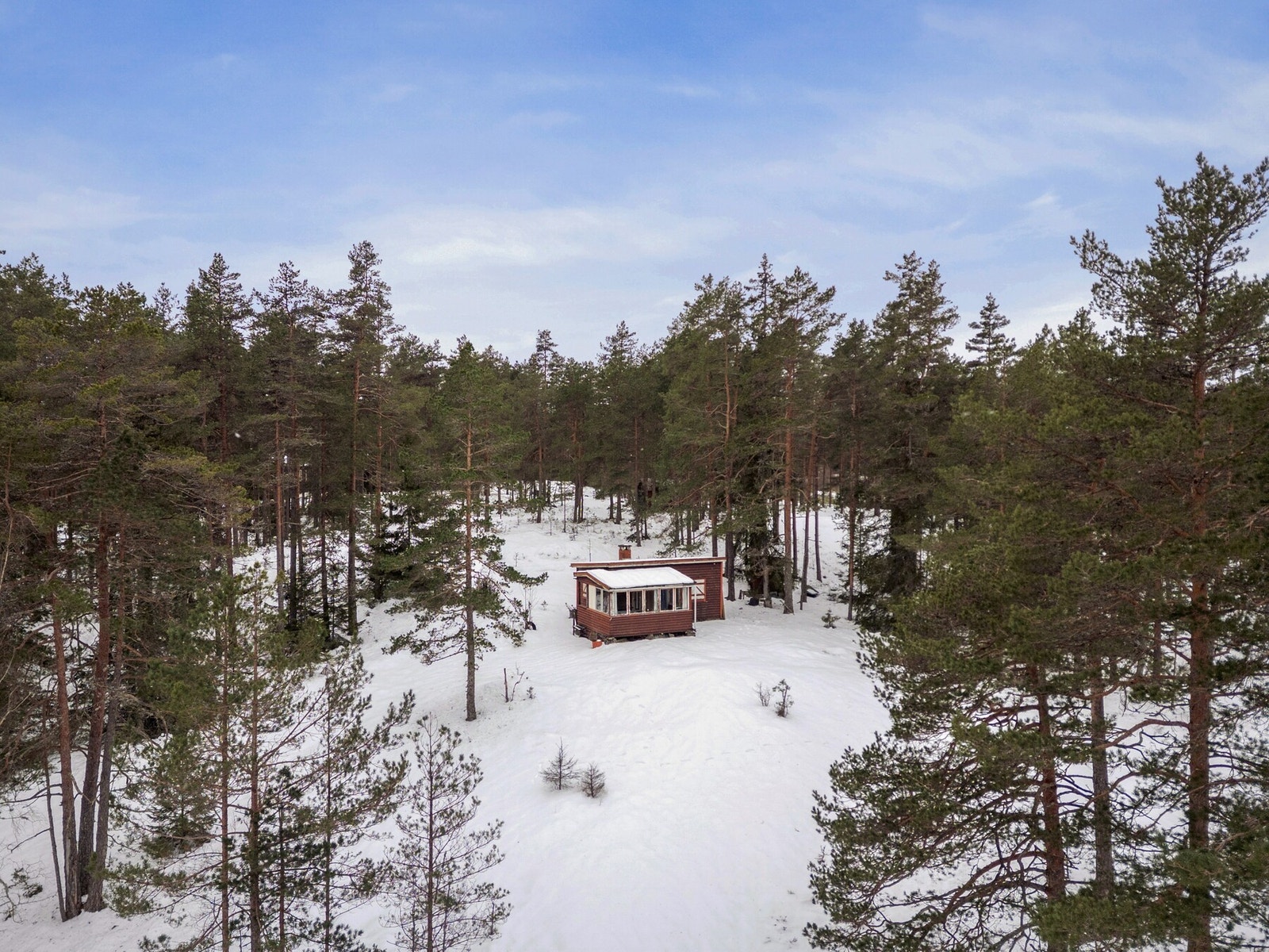 Eiendommen består av en hytte, et uthus og en garasje Galleribilde