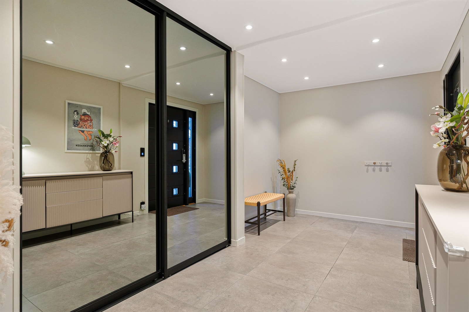 Innbydende entré i lyse farger og flislagt gulv . Det er god plass til oppbevaring i skyvedørgarderfobe. Galleribilde