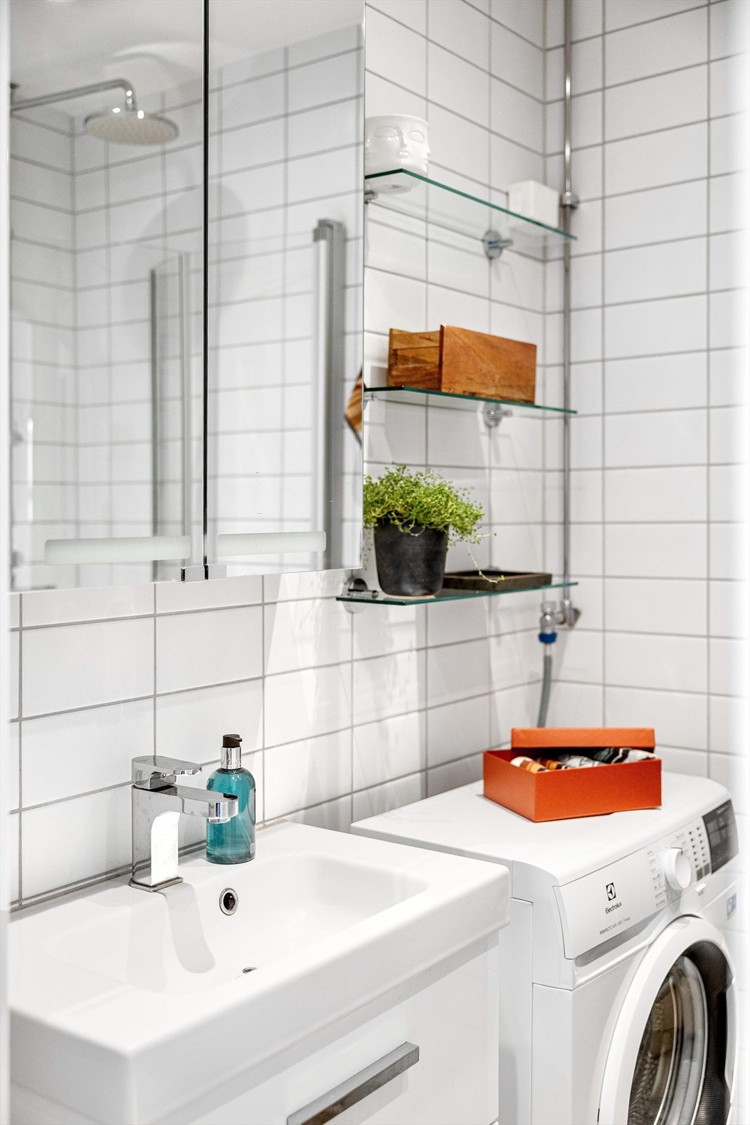 Badet er innredet med servant med underskap, vegghengt toalett og dusjvegger i glass. Det er opplegg for vaskemaskin og naturlig ventilasjon. Galleribilde