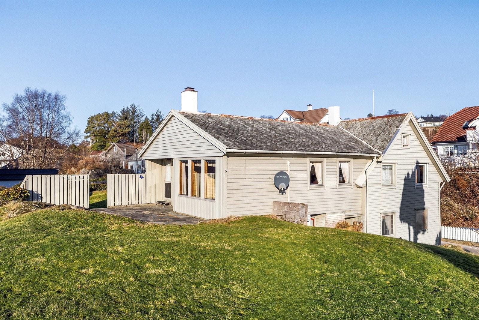 Usjenert uteplass i forkant av boligen. Stort plenareal på tomten. Galleribilde