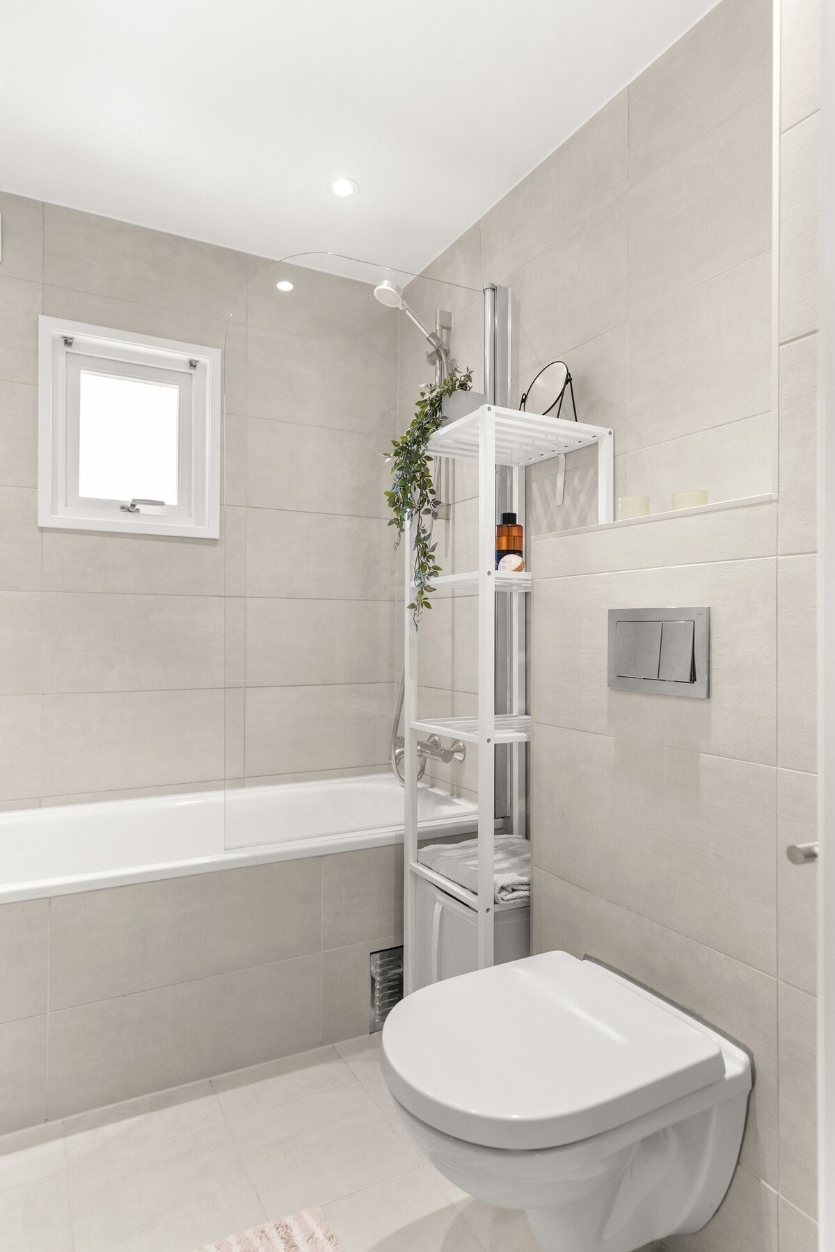 Badet er innredet med servant på baderomsinnredning med skuffer under, speilskap med integrert belysning, innmuret badekar samt vegghengt toalett. Galleribilde