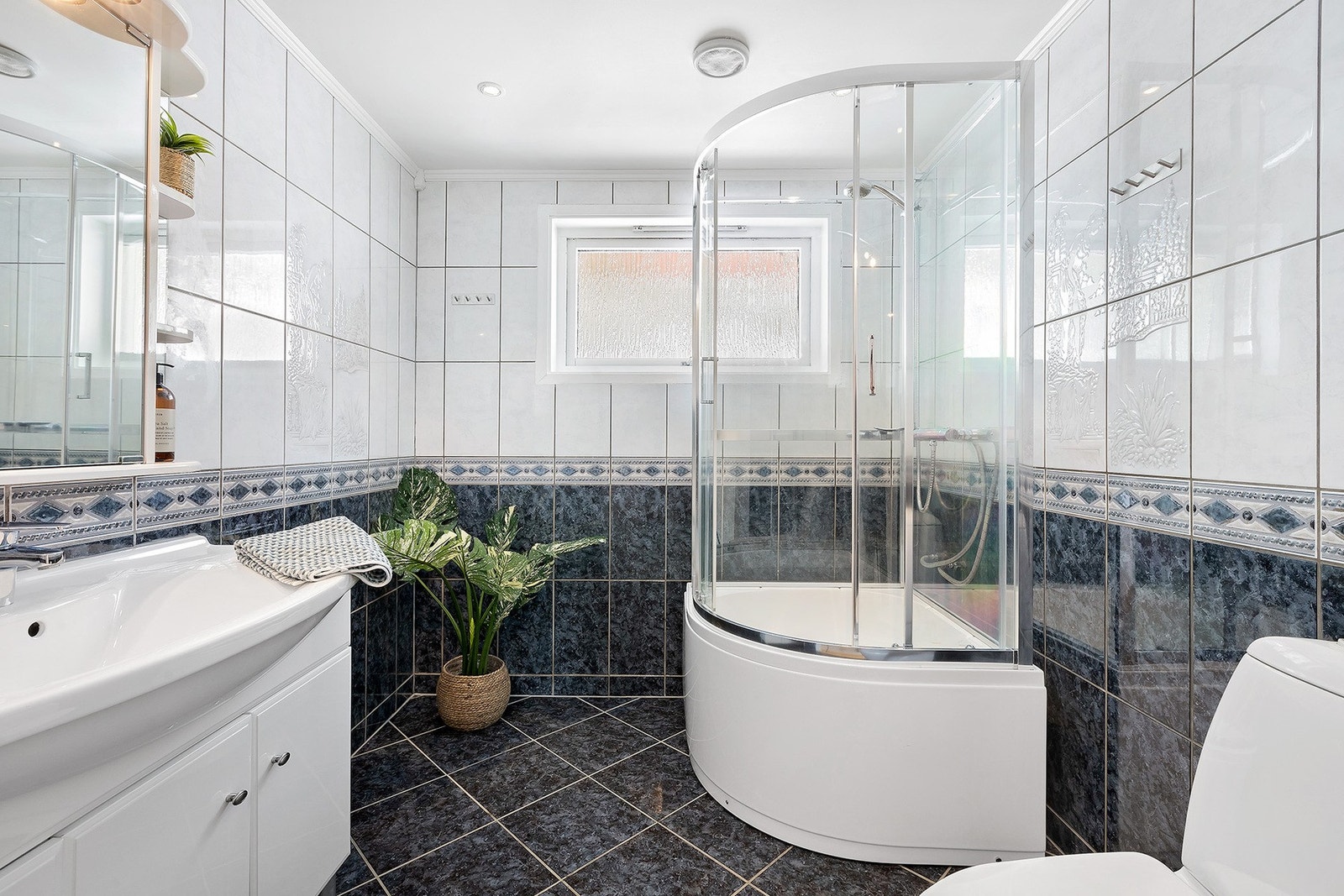 Bad i 1. etasje har flislagt gulv og vegger, og gulvvarme. Badet var overflaterenovert i 2009. Galleribilde