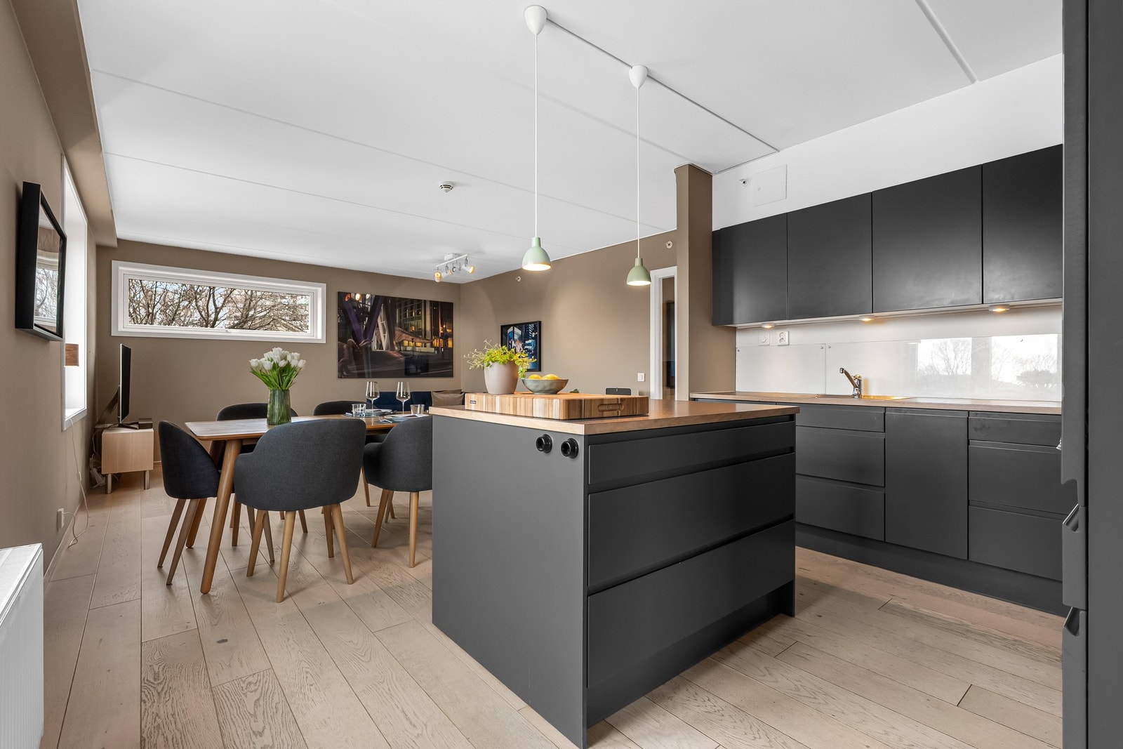 Innredningen har glatte fronter i grå utførelse og og benkeplate av laminat. Galleribilde