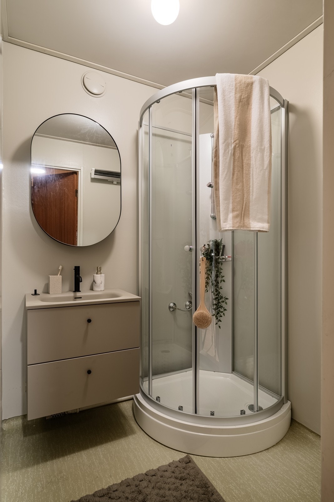 Bad med nyere baderomsmøbler og dusj Galleribilde