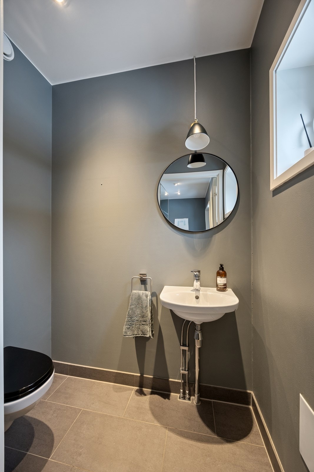 I tilknytning til entreen finner man et toalettrom som er malt i en mørk og behagelig farge og utstyrt med vegghengt toalett og servant. I gulvet har man varmekabler. Galleribilde