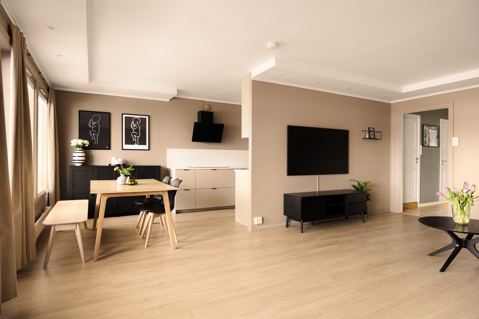 Den åpne løsningen mot stuen skaper en sosial og luftig atmosfære, hvor matlaging og samvær går naturlig hånd i hånd. Gulv og vegger i stue/kjøkken ble pusset opp i 2023. Galleribilde