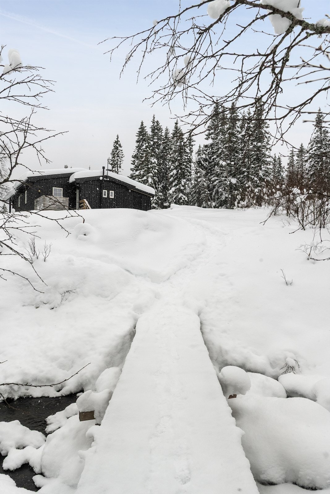 Det er ikke etablert kjøreadkomst til eiendommen.
Selger parkerer i dag i en parkeringslomme langs hovedveien og går deretter over en liten bru og opp til hytta. Galleribilde