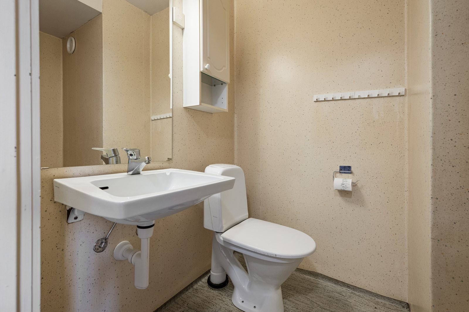 Badet har belegg på gulv- og veggoverflater, og det er malt betong i himlingen. Galleribilde