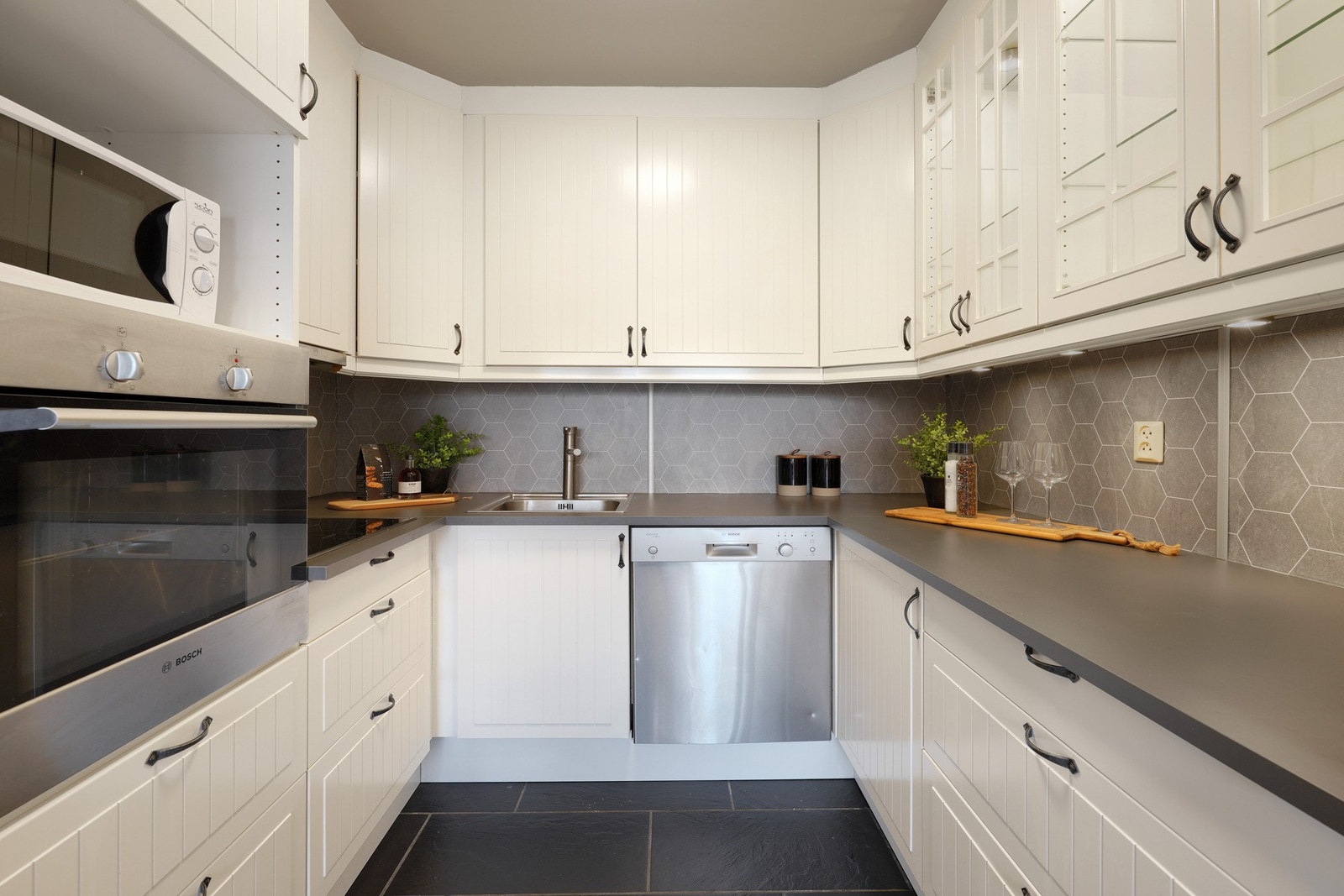 Tidløst kjøkken med helt ny benkeplate. Fliser på gulv. Galleribilde