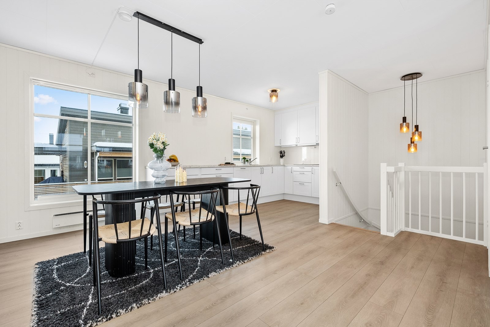 Hvitmalte overflater fremhever det tidsmessige laminatgulvet. Galleribilde