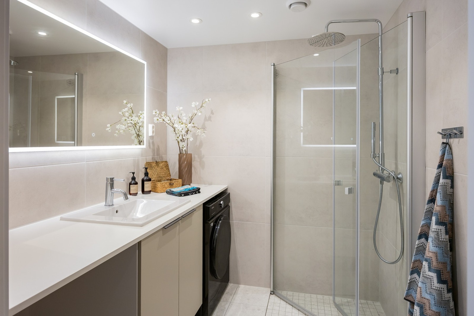 Lekkert bad med flislagte overflater, behagelig gulvvarme og diskret downlights med dimming. Galleribilde