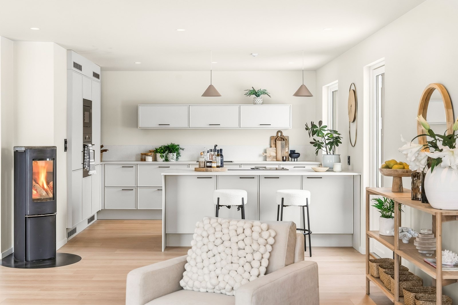 Kjøkkeninnredningen har skap med glatte, fabrikklakkerte trefronter, samt laminat benkeplate med planlimt kum i kompositt. Galleribilde