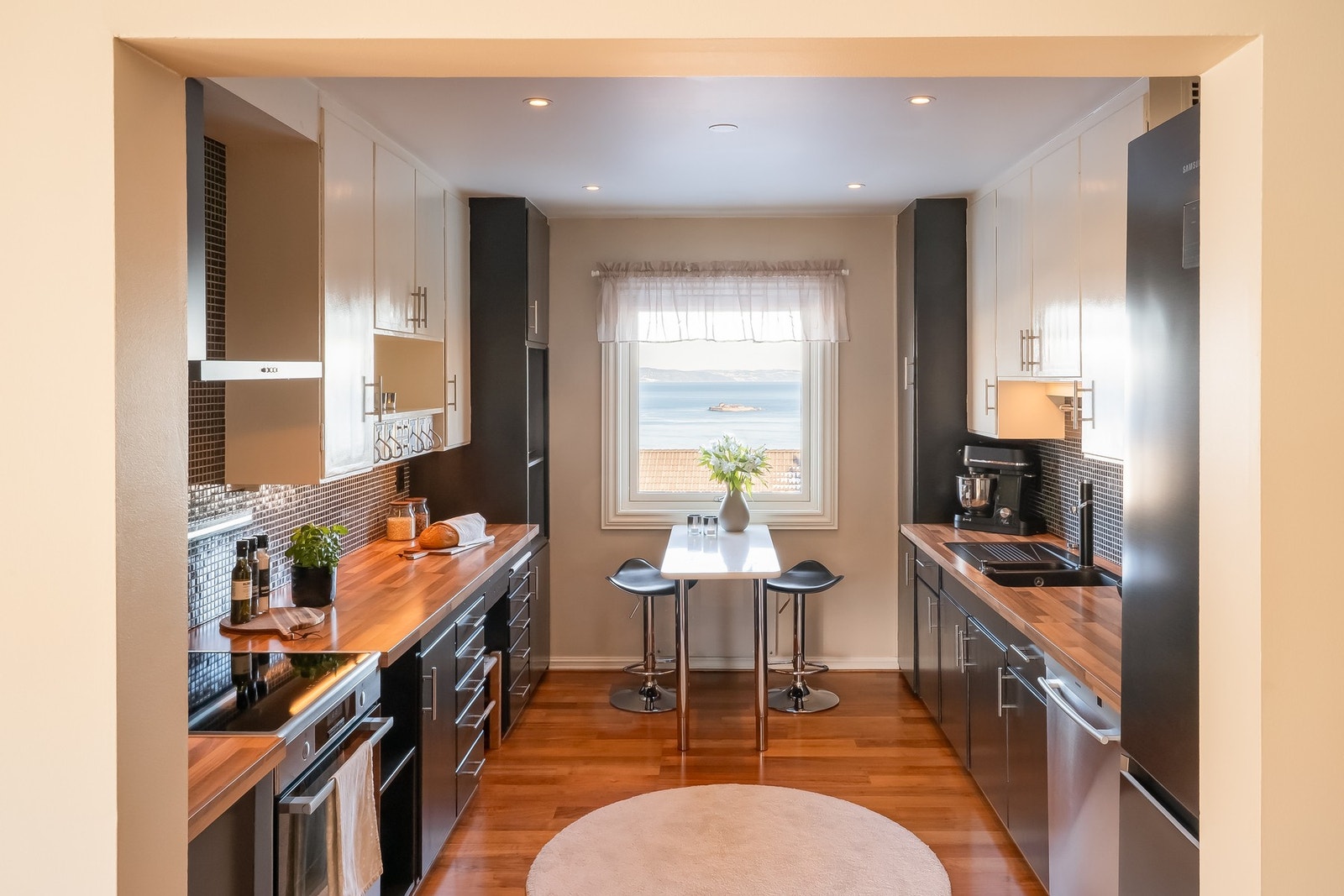 Pent kjøkken med mye skap- og benkeplass. Galleribilde