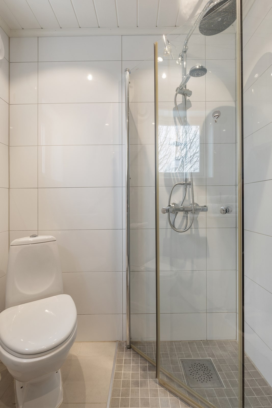 Nyere innredning med nedfelt servant, toalett, dusjvegger/hjørne og opplegg for vaskemaskin. Galleribilde