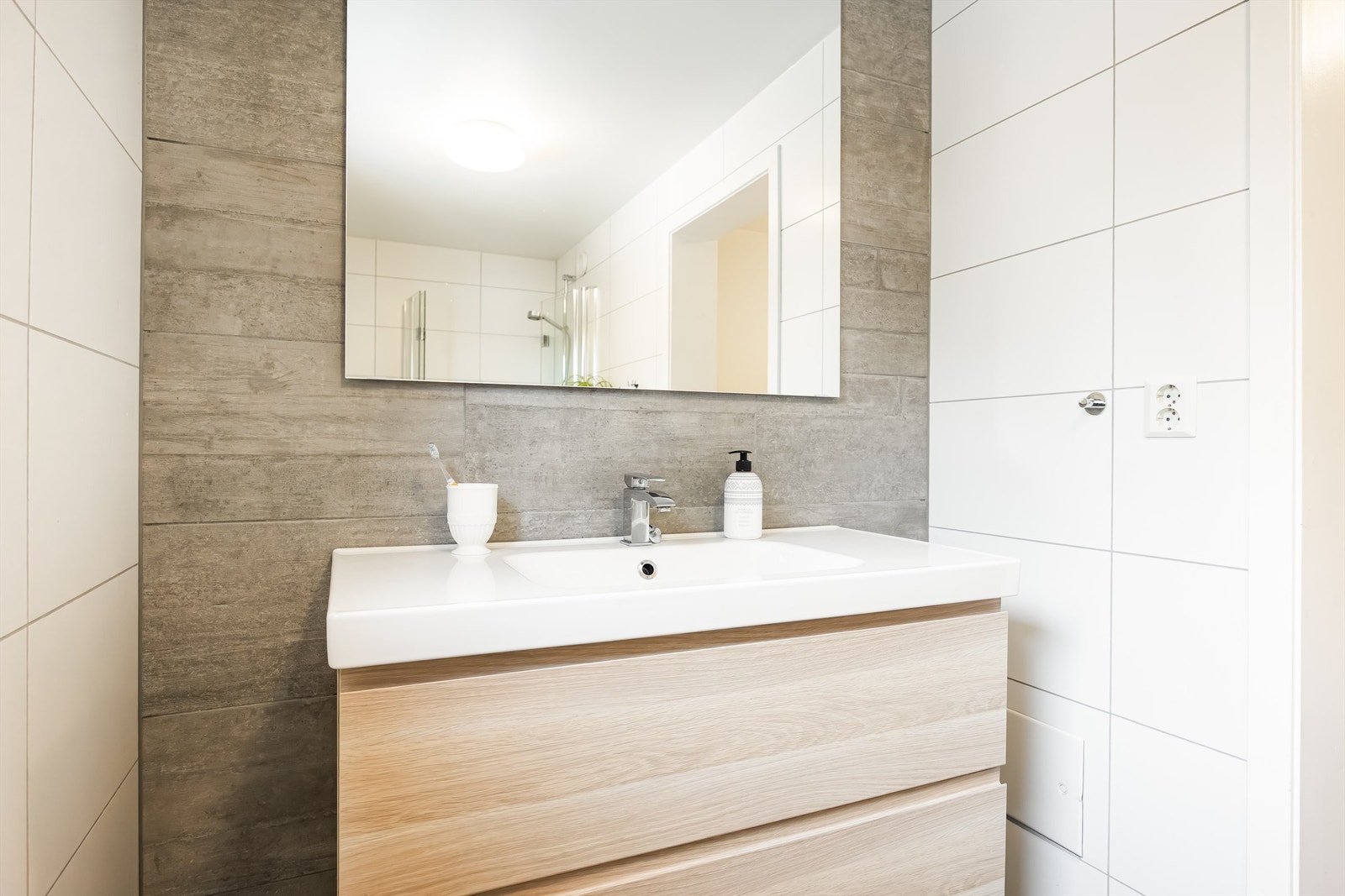 Innredningen har glatte fronter og heldekkende servant med ett-greps armatur, speil og stikkontakter. Galleribilde