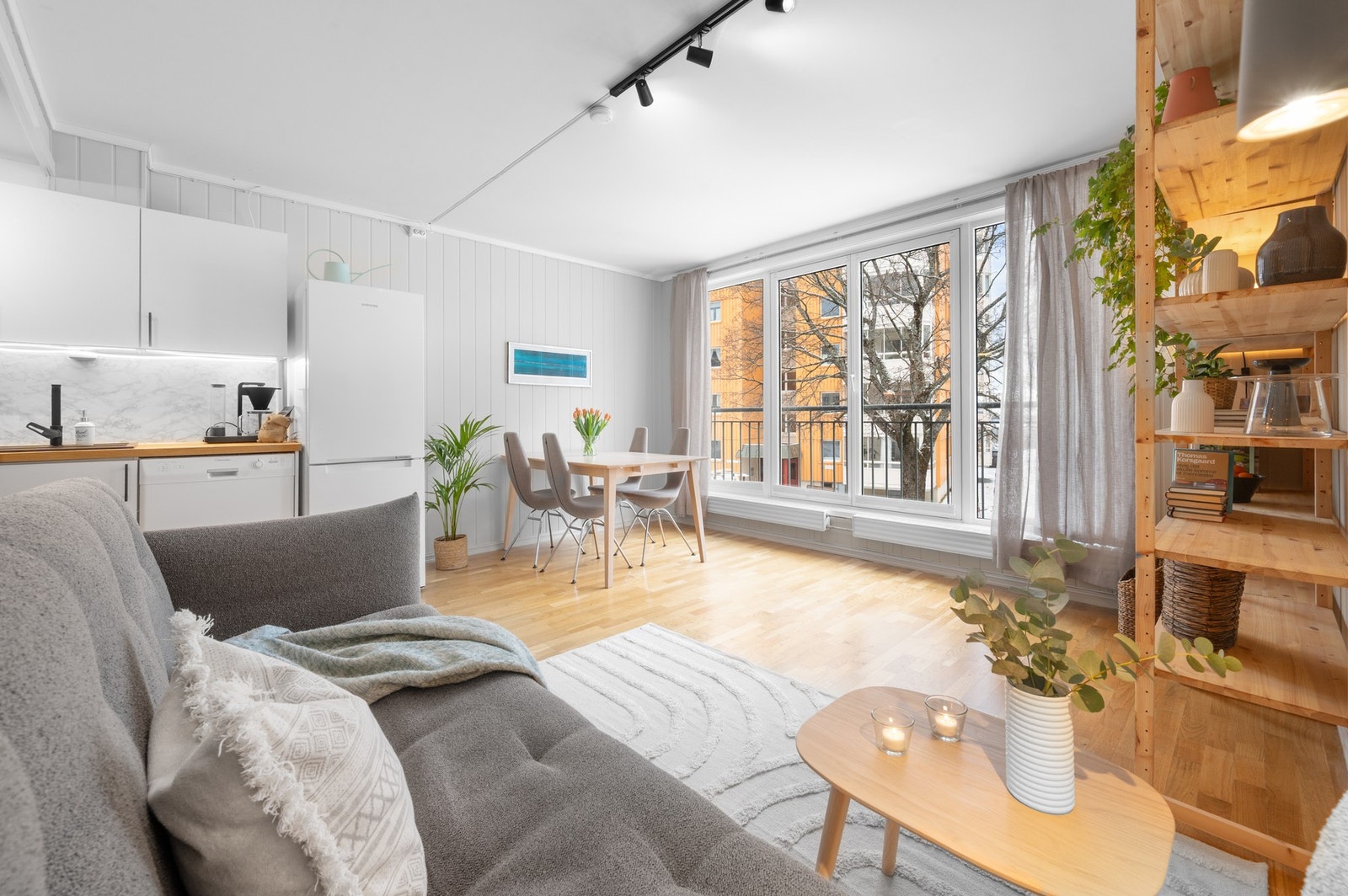 Flere store vindusflater gir leiligheten rikelig med naturlig lys og dette bidrar til en behagelig atmosfære i hele leiligheten. Galleribilde