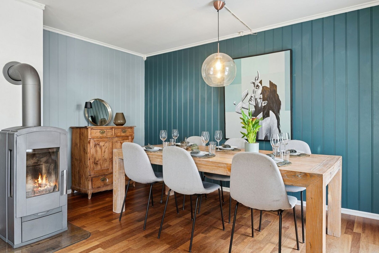 Stemningsfull spisestue med god plass rundt bordet og vedovn som skaper en lun og innbydende atmosfære. Galleribilde
